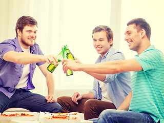 Image showing smiling friends with beer and pizza hanging out