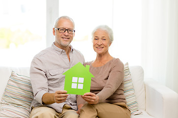 Image showing happy senior couple hugging on sofa at home