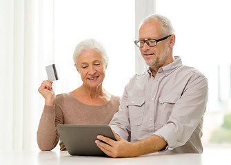 Image showing happy senior couple with tablet pc and credit card