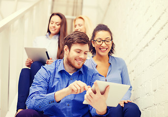 Image showing team with tablet pc computer sitting on staircase