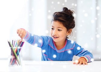 Image showing smiling little girl with pencils drawing at home