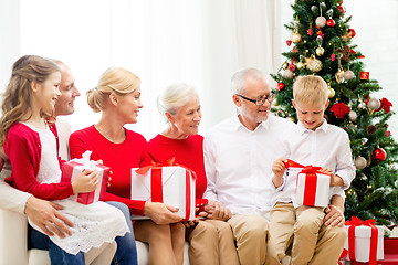 Image showing smiling family with gifts at home