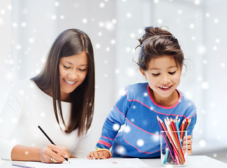 Image showing mother and daughter with coloring pencils indoors