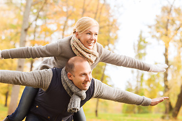 Image showing smiling couple having fun in autumn park