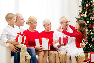 Image showing smiling family with gifts at home