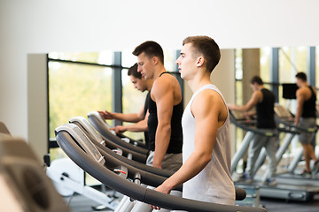 Image showing group of men exercising on treadmill in gym