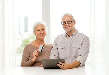 Image showing happy senior couple with tablet pc and credit card