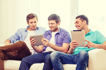 Image showing smiling friends with tablet pc computers at home