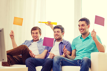 Image showing happy male friends with flags and vuvuzela