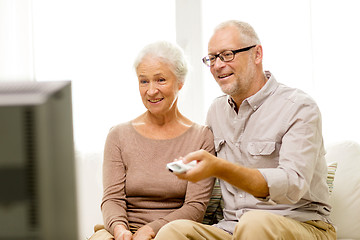 Image showing happy senior couple watching tv at home