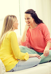 Image showing two girlfriends having a talk at home