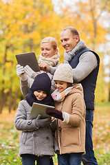 Image showing happy family with tablet pc in autumn park