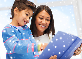 Image showing mother and daughter with book indoors