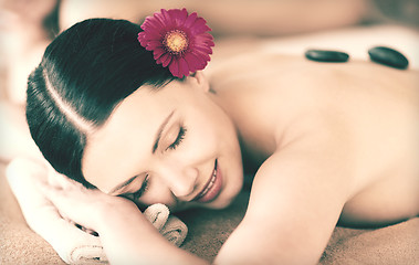 Image showing woman in spa with hot stones