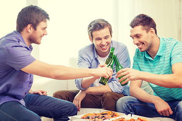 Image showing smiling friends with beer and pizza hanging out