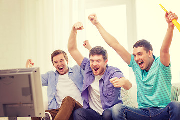 Image showing happy male friends with vuvuzela watching sports