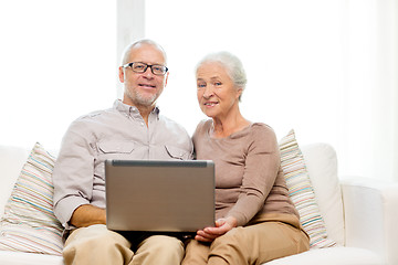 Image showing happy senior couple with laptop at home