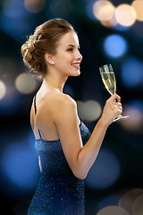 Image showing smiling woman holding glass of sparkling wine