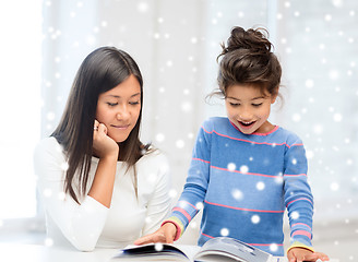 Image showing mother and daughter with book indoors