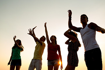 Image showing smiling friends dancing on summer beach