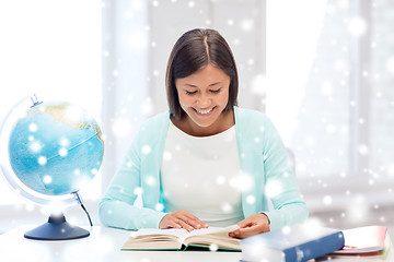 Image showing smiling young woman with globe and tablet pc