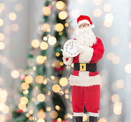 Image showing man in costume of santa claus with clock