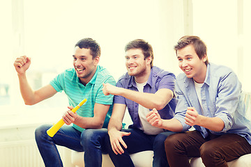Image showing happy male friends with vuvuzela watching sports