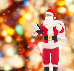 Image showing man in costume of santa claus with notepad and bag