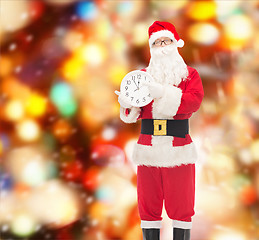 Image showing man in costume of santa claus with clock