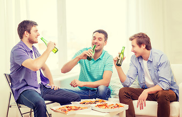 Image showing smiling friends with beer and pizza hanging out
