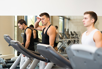 Image showing group of men exercising on treadmill in gym