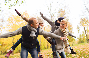 Image showing happy family having fun in autumn park