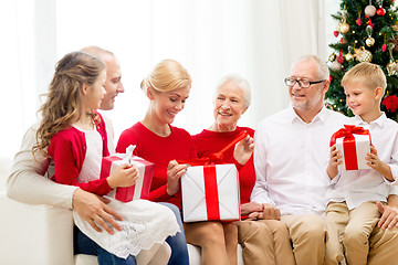 Image showing smiling family with gifts at home