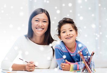 Image showing mother and daughter with coloring pencils indoors