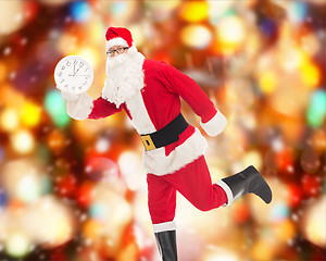 Image showing man in costume of santa claus with clock