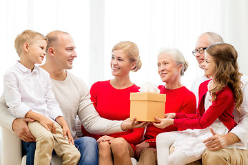Image showing smiling family with gift at home