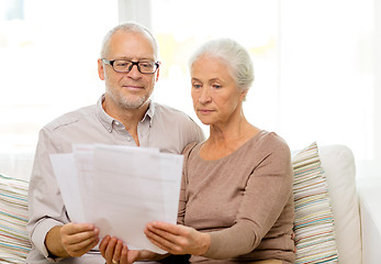 Image showing senior couple with papers at home