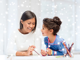 Image showing mother and daughter with coloring pencils indoors