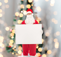 Image showing man in costume of santa claus with billboard