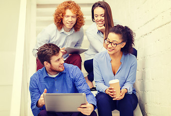 Image showing team with laptop and tablet pc on staircase