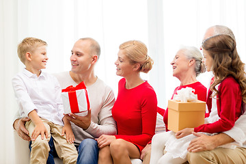 Image showing smiling family with gifts at home