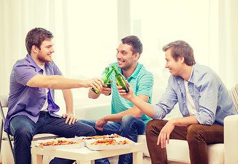 Image showing smiling friends with beer and pizza hanging out