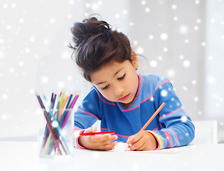 Image showing little girl with pencils drawing at home