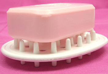 Image showing Pink soap on a soap dish on a pink background