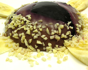 Image showing Chocolate pudding with blueberries, banana and pieces of almonds