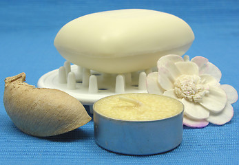 Image showing Beige soap with decoration articles on a light blue background