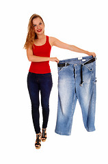 Image showing Woman holding big pants.