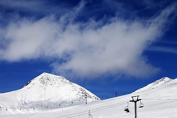 Image showing Chair-lift and ski slope at sun day
