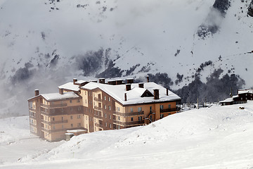 Image showing Hotel and ski slope at fog day