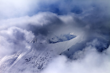 Image showing Off-piste slope in sunlight multicolor clouds